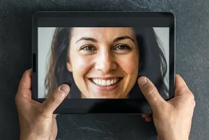 young woman smiling on a tablet